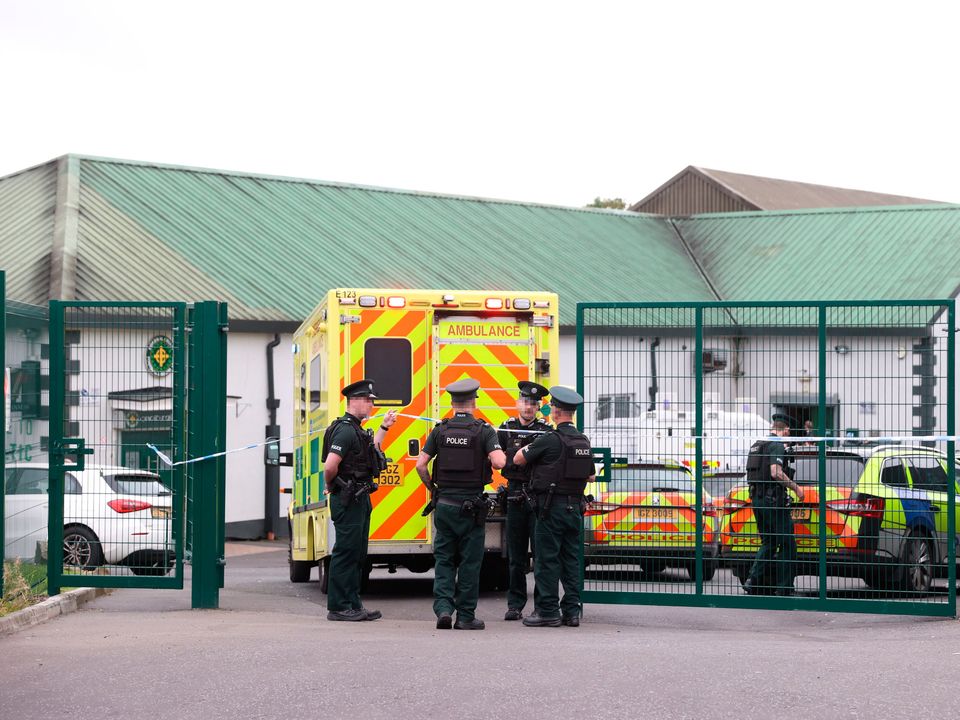 Officers from the PSNI stand beside an ambulance at the scene of a shooting at the clubhouse of Donegal Celtic Football Club, in west Belfast. (Liam McBurney/PA Wire)