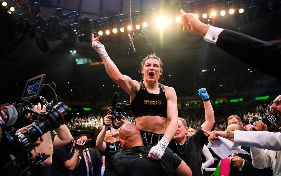 Katie Taylor is lifted into the air by her coach Ross Enamait after her undisputed world lightweight championship victory over Amanda Serrano at Madison Square Garden. Photo by Stephen McCarthy/Sportsfile