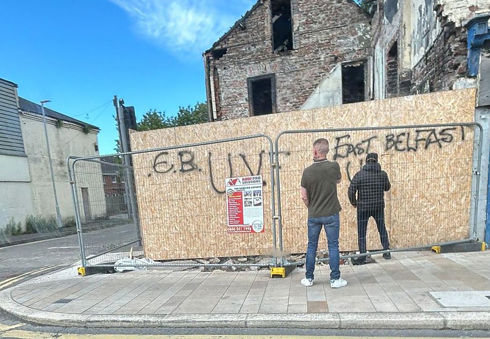 Men paint pro-East Belfast UVF messages after the show of strength