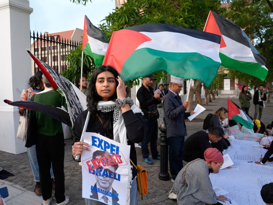 Pro-Palestinian supporters protest outside Parliament in Cape Town, South Africa, Tuesday, Nov. 21, 2023. The majority of MP's voted to close the Israeli embassy in South Africa over the war in Gaza. (AP Photo/Nardus Engelbrecht)