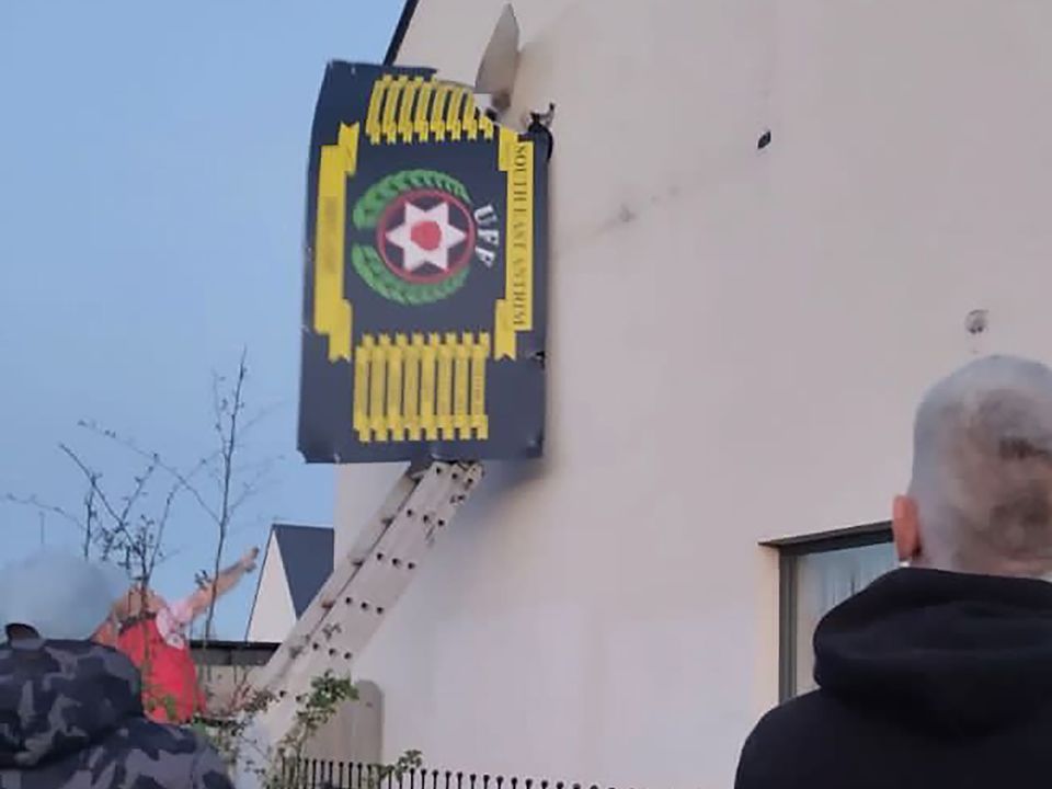 A number of men arrived at the Weavers Grange area of Newtownards with ladders to remove signs and poster from building which supports the UFF.