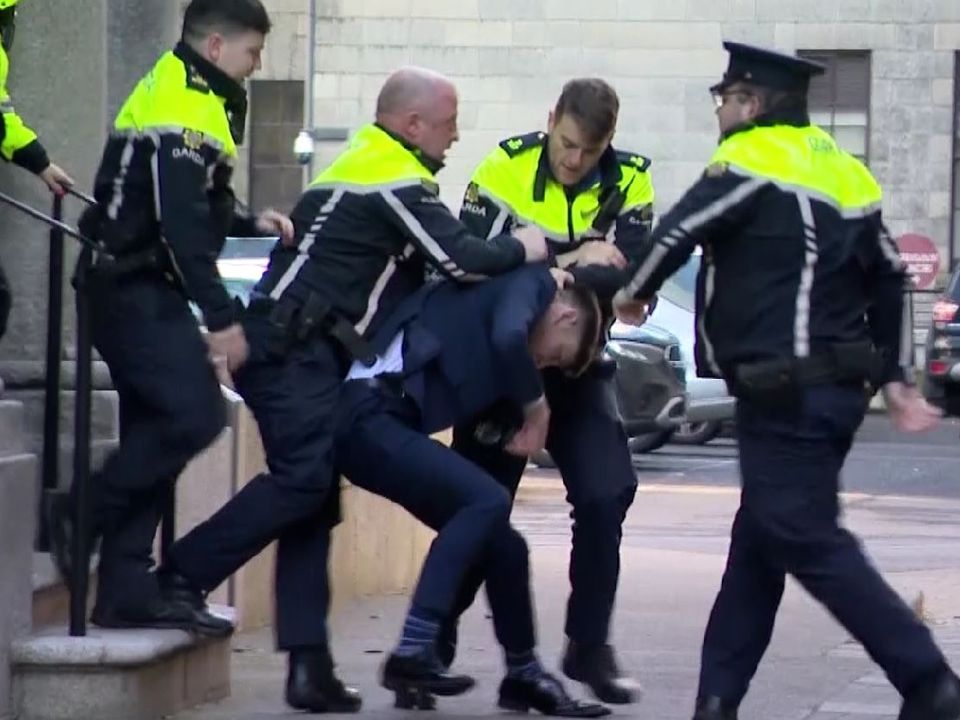 Simeon Burke being removed from court