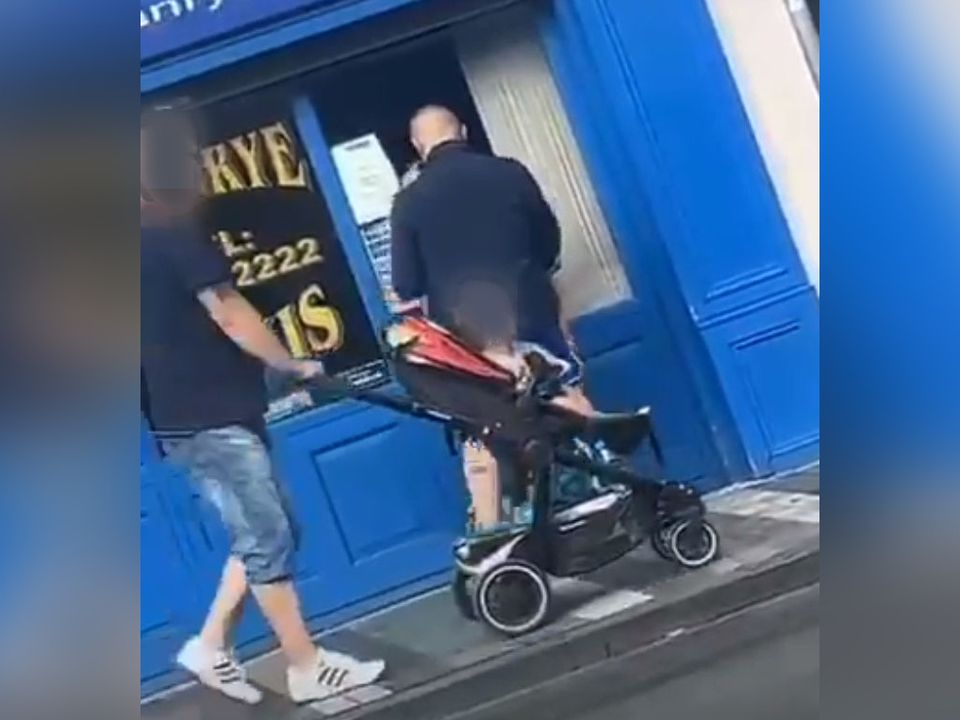 A passer-by pushes a pram