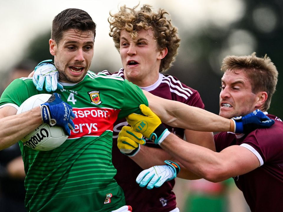 Mayo's Lee Keegan is tackled by Conor Campbell, left, and Gary O'Donnell of Galway