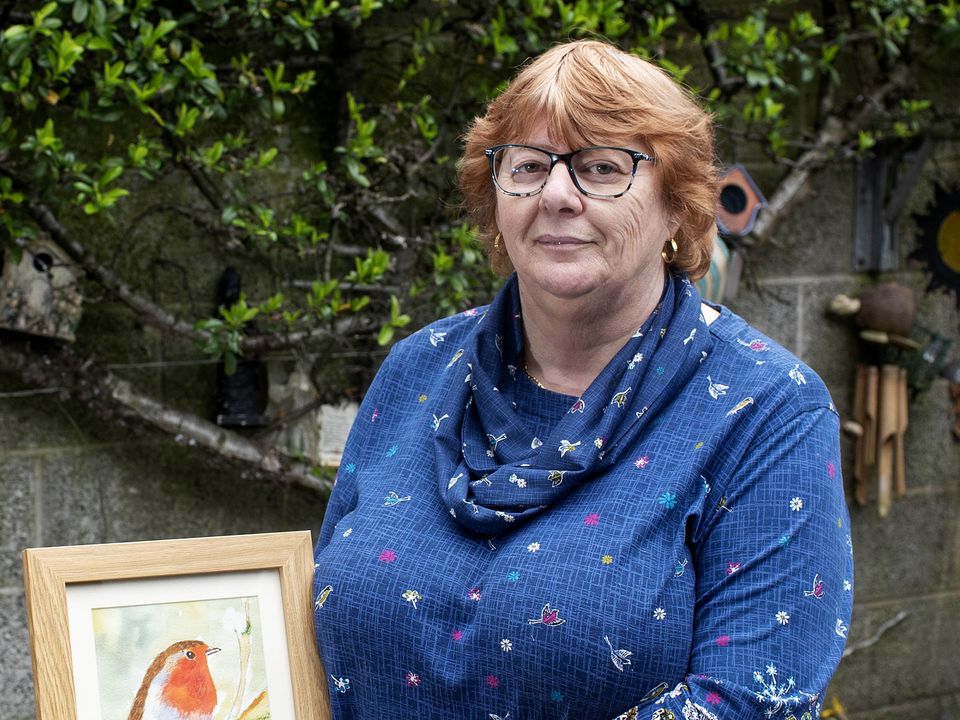 Breda Parle Breslin poses with one of her paintings at her home in Carrick-on-Suir