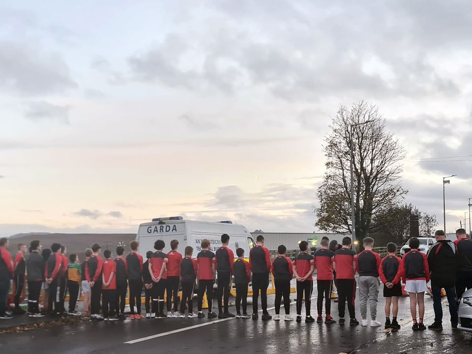 Newly crowned county champions, St Michael’s Creeslough under-13s, stand in silent tribute at the Applegreen Service Station where 10 people lost their lives in October