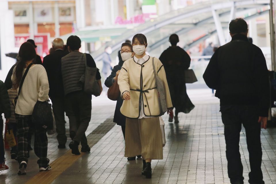 People wear face masks to help curb the spread of coronavirus in Tokyo (Koji Sasahara/AP)