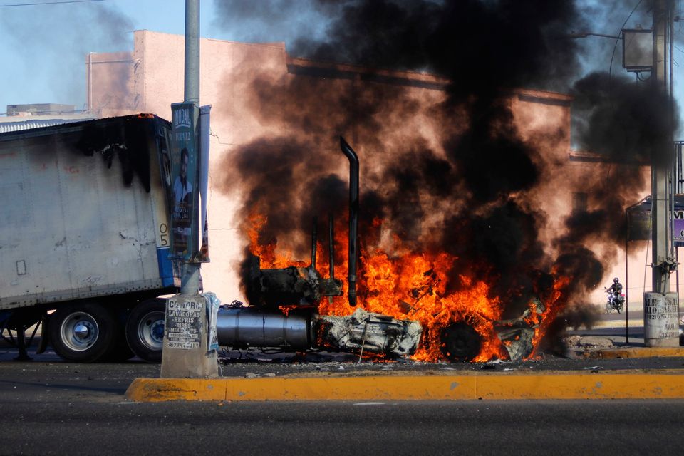 A truck burns on a street in Culiacan, Sinaloa state, Mexico, in response to the arrest of alleged drug trafficker Ovidio Guzmán. Photo: Martin Urista/AP