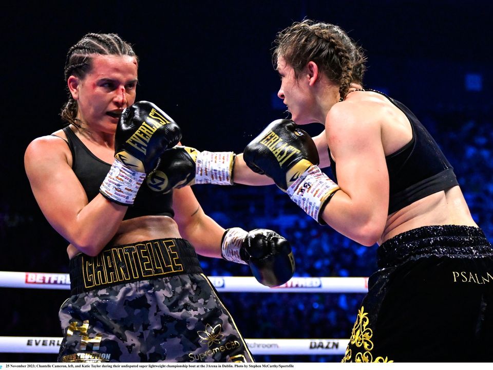 25 November 2023; Chantelle Cameron, left, and Katie Taylor during their undisputed super lightweight championship bout at the 3Arena in Dublin. Photo by Stephen McCarthy/Sportsfile