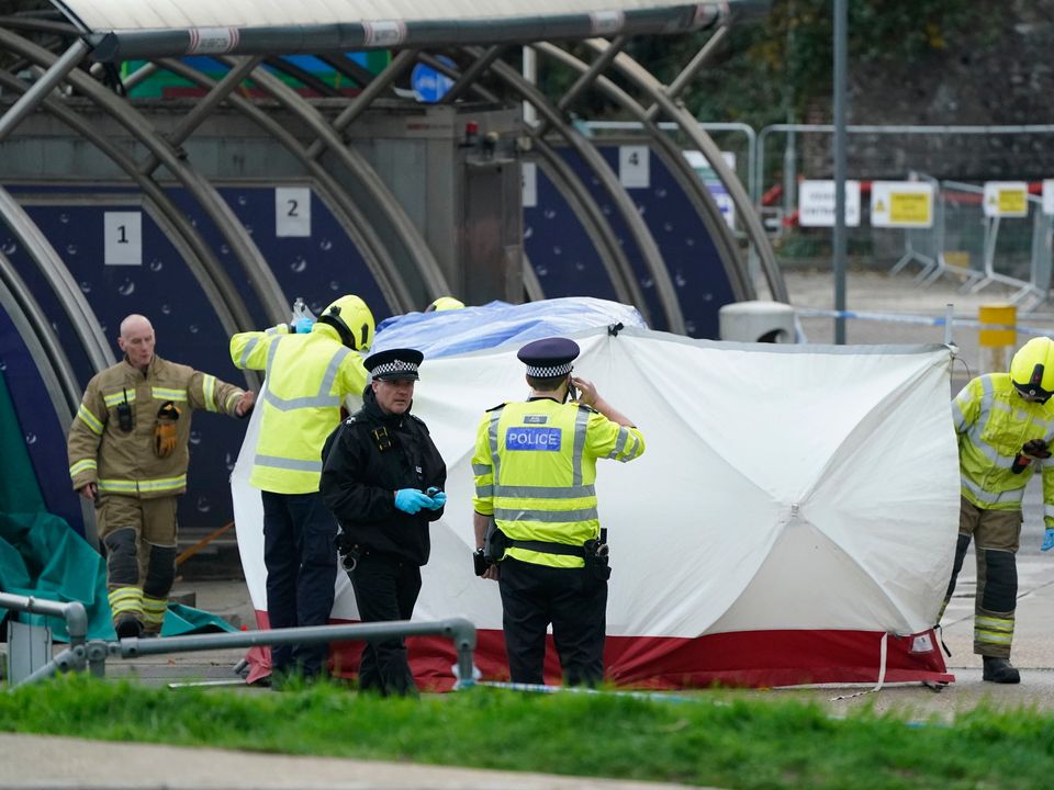 Emergency services erect a tent around the car allegedly involved in an incident near the migrant processing centre in Dover, Kent. Photo: Andrew Ma/PA