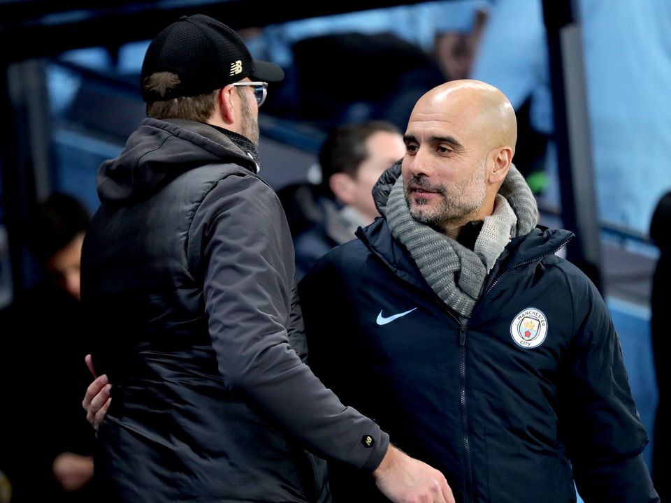 Manchester City manager Pep Guardiola, right, and Liverpool boss Jurgen Klopp are locked in a Premier League title battle (Richard Sellers/PA)
