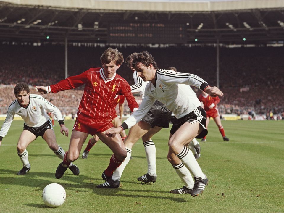 Rare flashpoint: Liverpool’s Kenny Dalglish (c) challenges Manchester United’s Irish defender Kevin Moran as Arthur Albiston (l) looks on during the 1983 Milk Cup final at Wembley Stadium. This final was one of few examples where these titans were in direct competiton with each other for a trophy