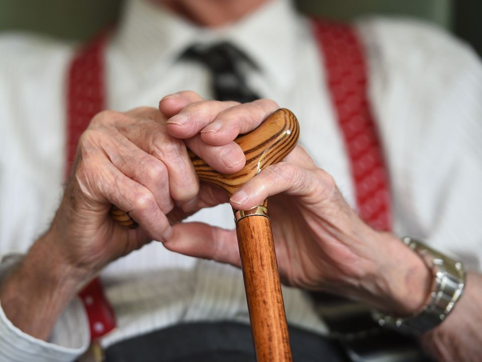 Elderly man holding a walking stick. Photo: File