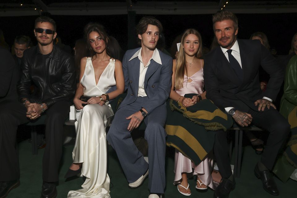 Romeo Beckham, singer Jackie Apostel, Cruz Beckham, Harper Beckham, and David Beckham attend the Victoria Beckham spring/summer 2025 collection in Paris (Vianney Le Caer/Invision/AP)