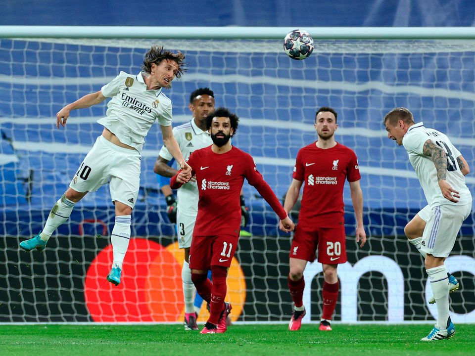 Real Madrid's Luka Modric heads clear against Liverpool in Madrid