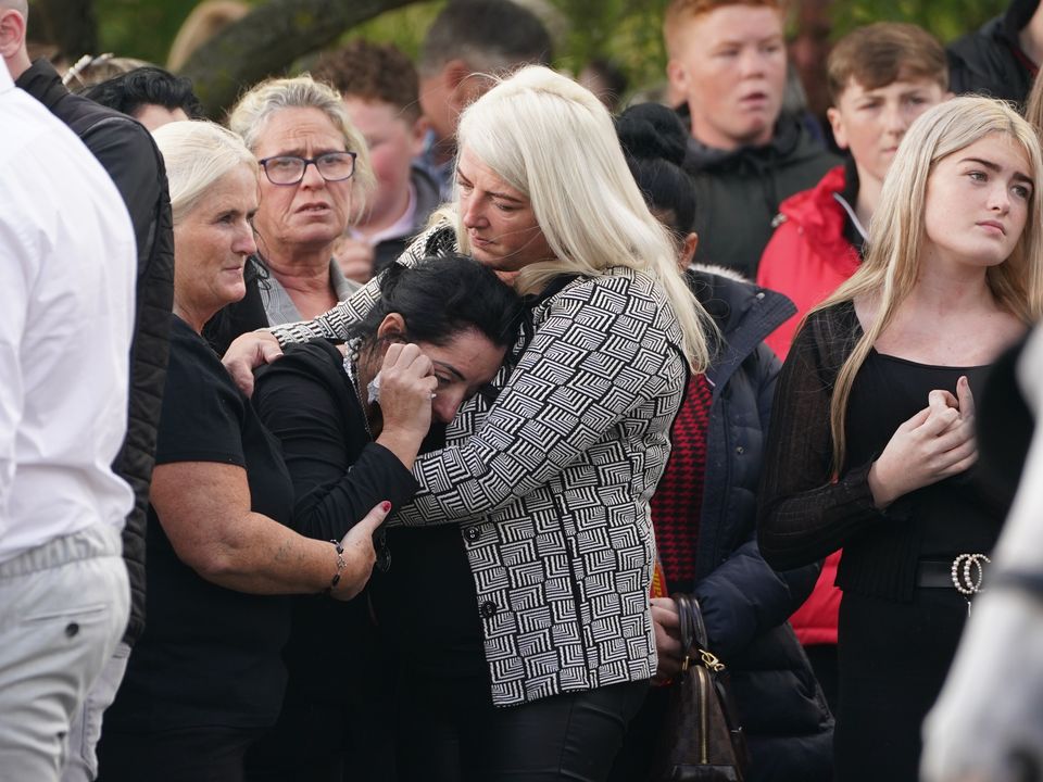 Margaret Cash McDonagh, the mother of Lisa Cash, 18, and her eight-year-old twin siblings, Christy and Chelsea Cawley, is consoled by other mourners. Picture: PA