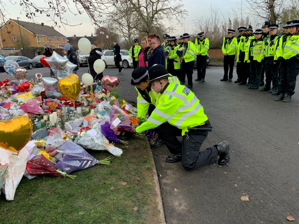 21 Officers from West Midlands Police lay bouquets of flowers and stood in silence near to the scene in Babbs Mill Park in Kingshurst, Solihull
