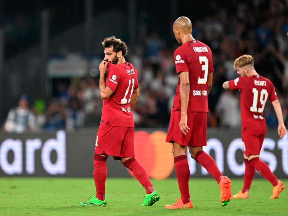 Liverpool's Mohamed Salah, Fabinho and Harvey Elliott react after Napoli's Andre-Frank Zambo Anguissa (not pictured) scored their second goal during the Champions League Group A match in Naples.