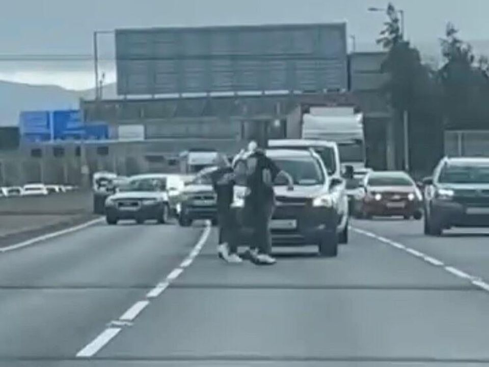 Two men exchange blows on the M50