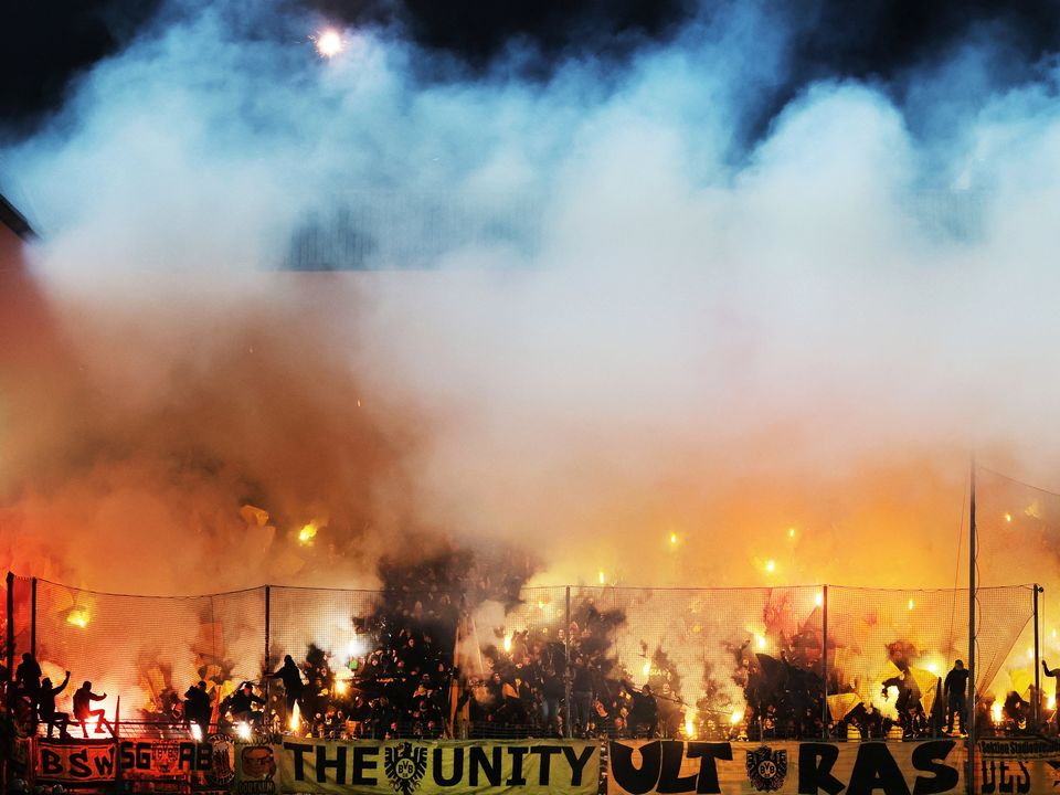 Borussia Dortmund fans fire flares at Ruhrstadion in Bochum, Germany last night.