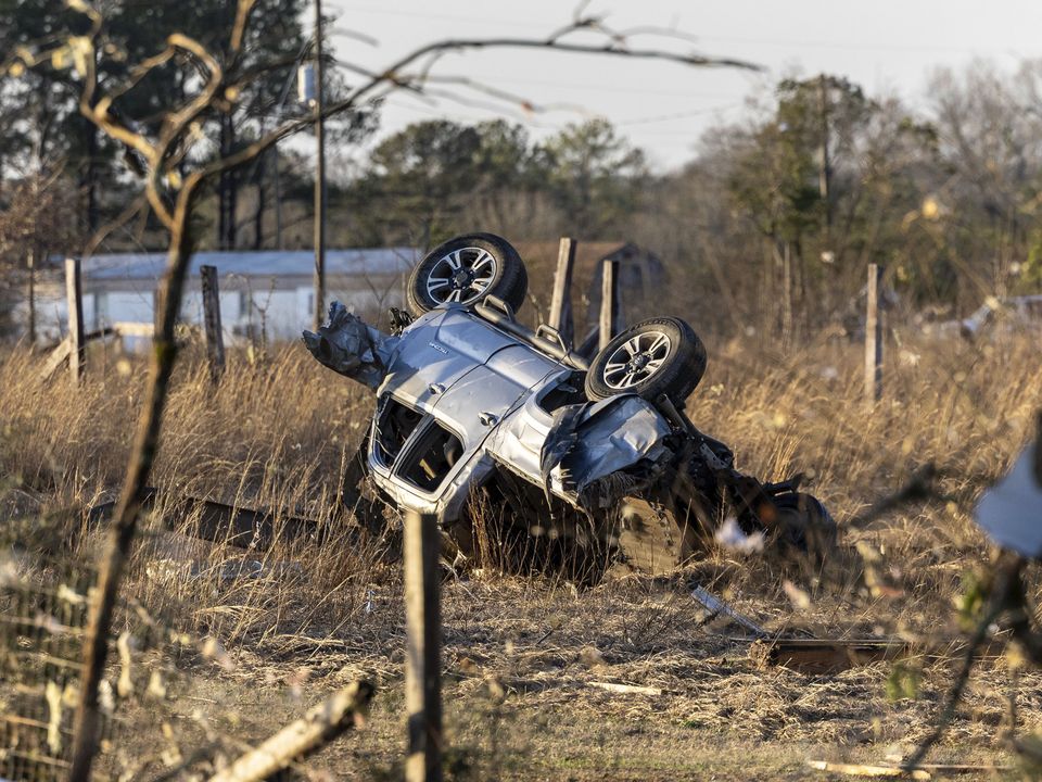 An SUV is overturned near 1349 County Road 43 in the aftermath from severe weather, Thursday, Jan. 12, 2023, in Prattville, Ala. A giant, swirling storm system billowing across the South spurred a tornado on Thursday that shredded the walls of homes, toppled roofs and uprooted trees in Selma, Alabama, a city etched in the history of the civil rights movement.(AP Photo/Vasha Hunt)