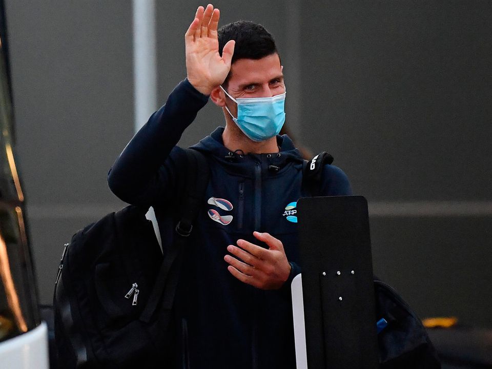 Novak Djokovic waves as he arrives at Adelaide Airport. (Photo by Mark Brake/Getty Images)