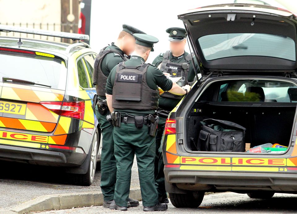 Police officers at the murder scene of Eamonn 'spud' O'Hanlon 36, who was stabbed to death in Gilford, County Down, in the early hours of Saturday.
