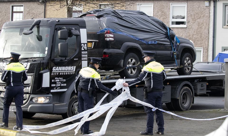 A vehicle is removed is removed from the scene this morning of a fatal shooting in which a man in his 20's was shot in the driveway of a house. Picture: Colin Keegan, Collins Dublin