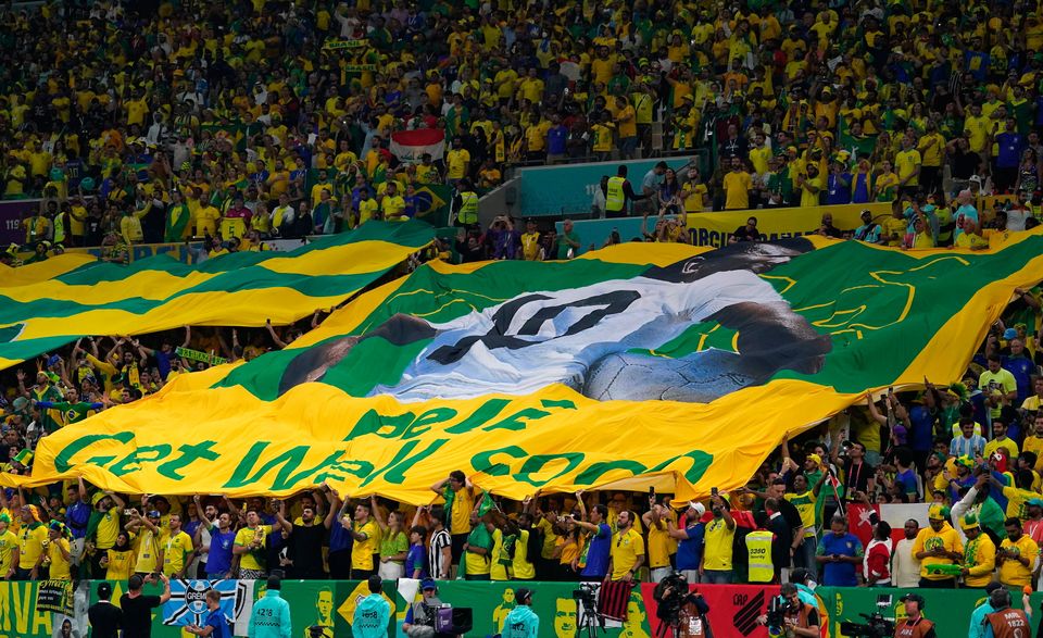 Fans in the stands with a giant Pele banner during the FIFA World Cup Group G match at the Lusail Stadium