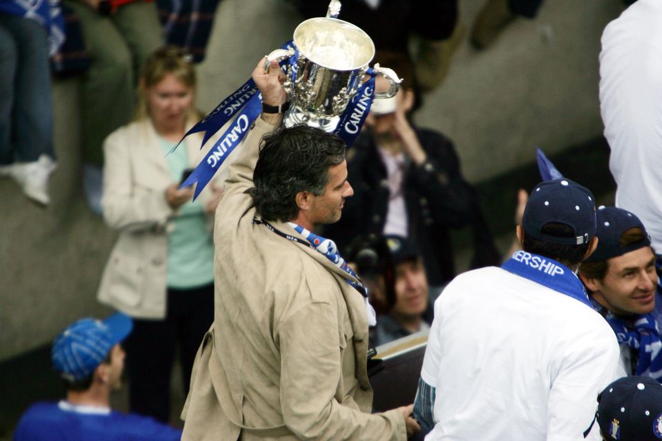 Jose Mourinho holds the League Cup trophy aloft (Chris Young/PA)