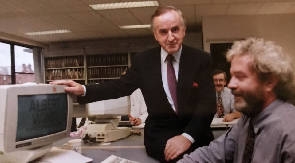 Former taoiseach Albert Reynolds watches Paddy at work in the newsroom.