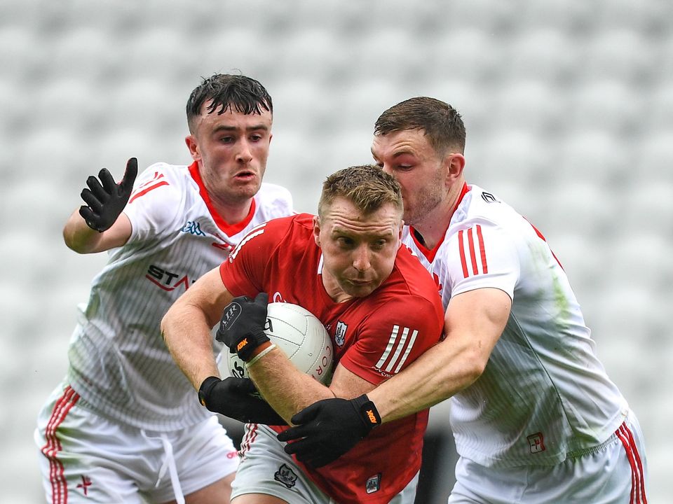4 June 2022; Brian Hurley of Cork is tackled by Daire Kelly, left, Sam Mulroy of Louth during the GAA Football All-Ireland Senior Championship Round 1 match between Cork and Louth at Páirc Ui Chaoimh in Cork. Photo by Eóin Noonan/Sportsfile