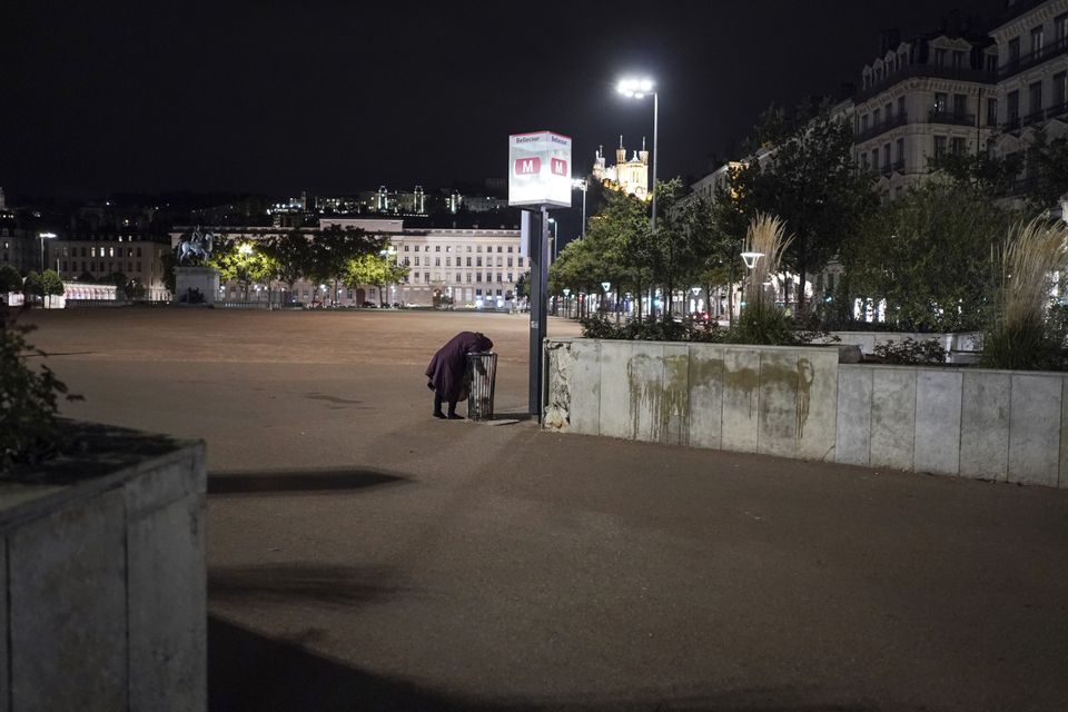 A homeless woman in the deserted centre of Lyon (Laurent Cipriani/AP)