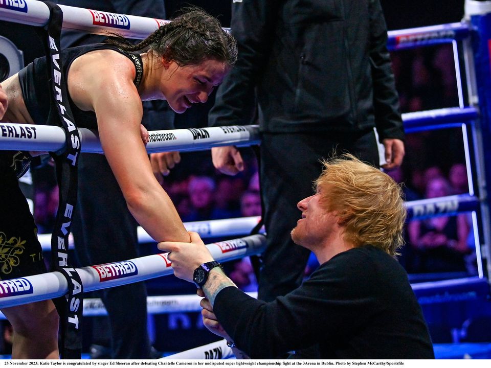 25 November 2023; Katie Taylor is congratulated by singer Ed Sheeran after defeating Chantelle Cameron in her undisputed super lightweight championship fight at the 3Arena in Dublin. Photo by Stephen McCarthy/Sportsfile