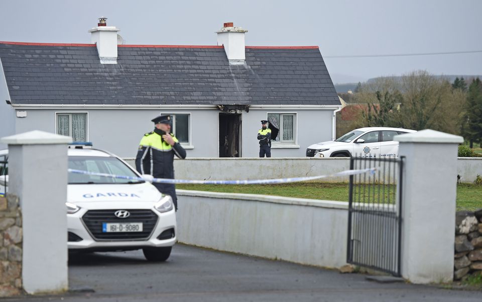 Gardaí at a house in Castlebar where a man, John Brogan (82), was found murdered on Sunday. Photo: Conor McKeown