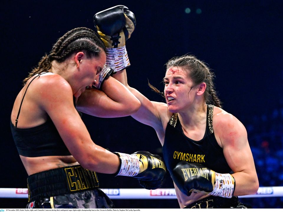 25 November 2023; Katie Taylor, right, and Chantelle Cameron during their undisputed super lightweight championship bout at the 3Arena in Dublin. Photo by Stephen McCarthy/Sportsfile