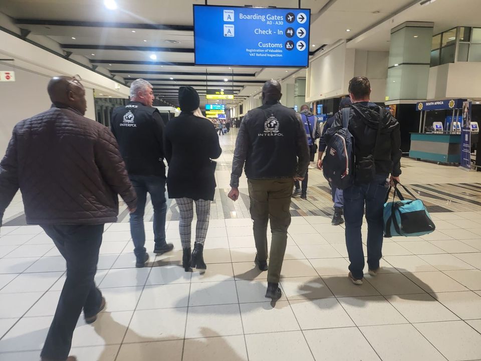 Ruth Lawrence under police escort in the airport
