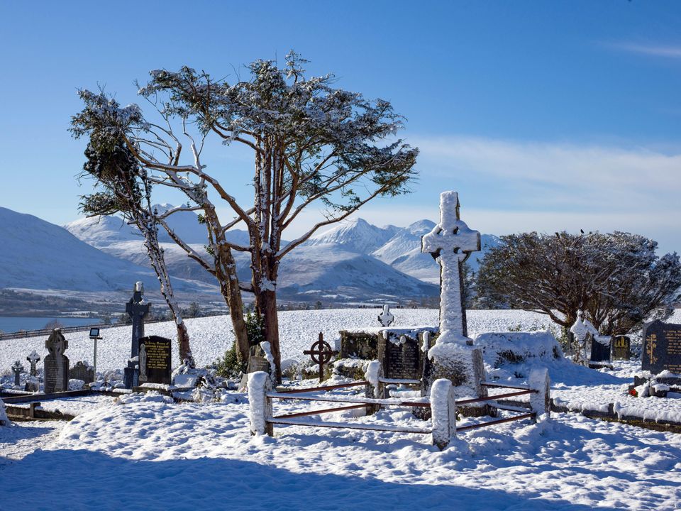 Snow covers the Old Aghadoe Graveyard in Killarney, Co Kerry, with the MacGillycuddy's Reeks in the background. Photo: Don MacMonagle
