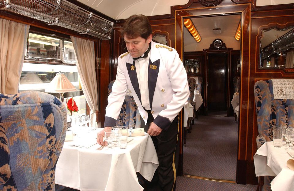 A steward sets a table on the Orient Express. Bloomberg photo by Andy Shaw