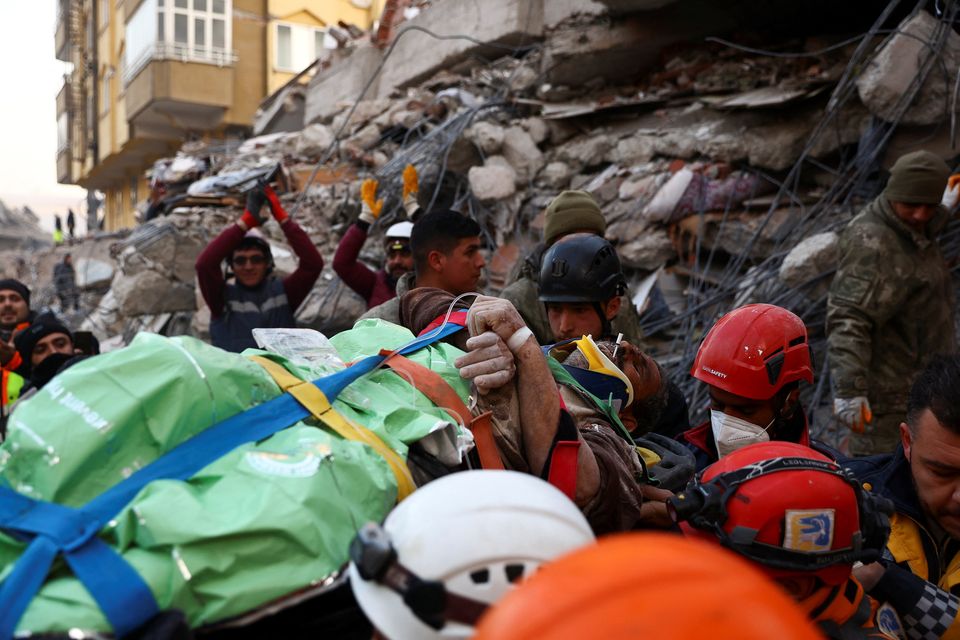 Rescuers from Turkey and United Hatzalah carry a 56-year-old survivor, Ali Korkmaz, in the aftermath of a deadly earthquake, in Kahramanmaras, Turkey, February 10, 2023. REUTERS/Ronen Zvulun