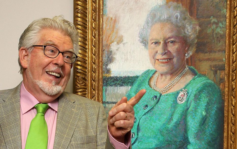 Harris poses next to his portrait of Queen Elizabeth II (PA)