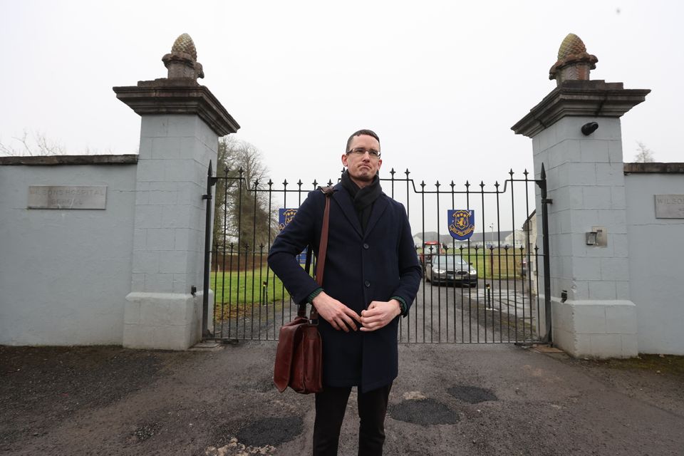 Enoch Burke stands outside the locked gates of Wilsons Hospital School, Multyfarnham following his release from Mullingar Garda station.   Picture; Gerry Mooney