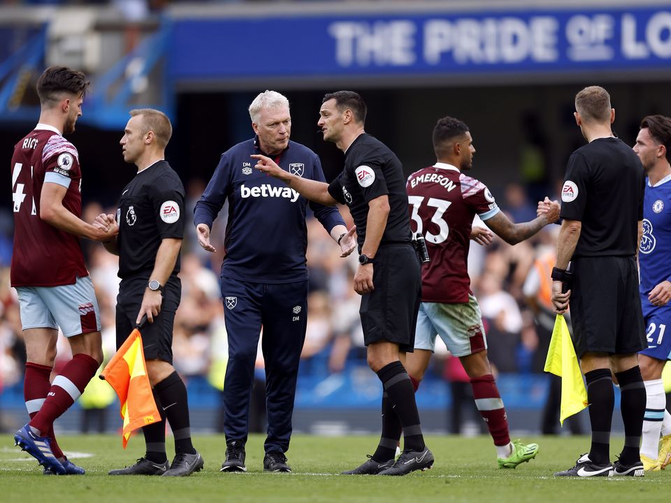 West Ham United manager David Moyes speaks to referee Andrew Madley after the final whistle of the Premier League match at Stamford Bridge, London. Picture date: Saturday September 3, 2022.