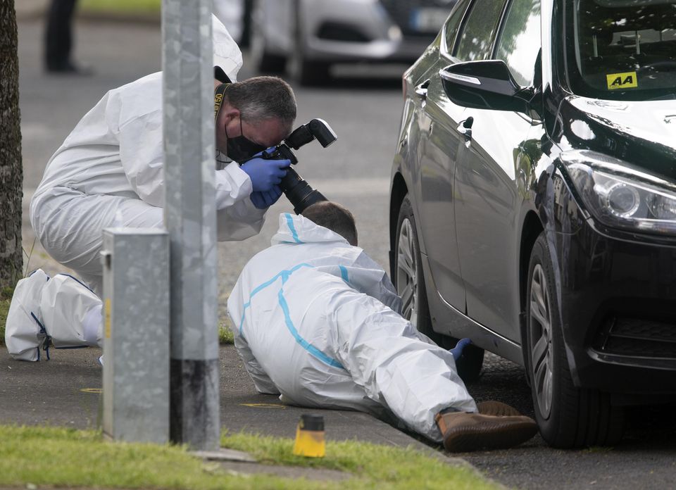 Members of the Garda Technical Bureau recover a bullet from a Garda car outside the house  on Whitechapel Grove, Blanchardstown. Picture Colin Keegan, Collins Dublin