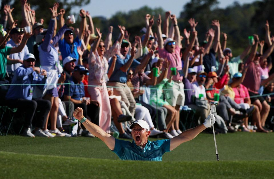 Rory McIlroy celebrates after chipping in for a birdie from the bunker on the 18th during his final round of The Masters at Augusta National Golf Club, Augusta, Georgia