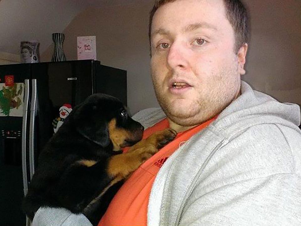 Wesley McCaughan nurses his Rottweiler when it was a pup.