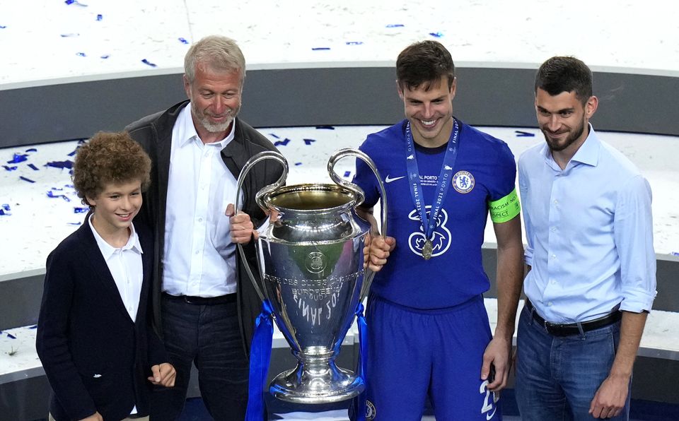Roman Abramovich, second left, with Cesar Azpilicueta, second right, and the Champions League trophy after Chelsea’s win over Manchester City in Porto in 2021 (Adam Davy/PA)