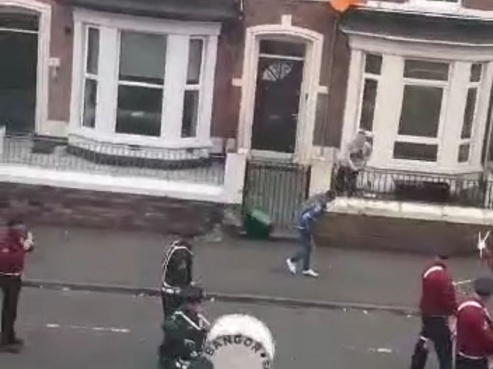 An Orange flute band had a bin hurled at them while marching through Agincourt Avenue on the 12th of July
Police said the man was arrested on suspicion of crimes including assault and disorderly behaviour following an altercation on Agincourt Avenue this morning.
A bin appears to be thrown at the band members(Image: Aoife Kelly)