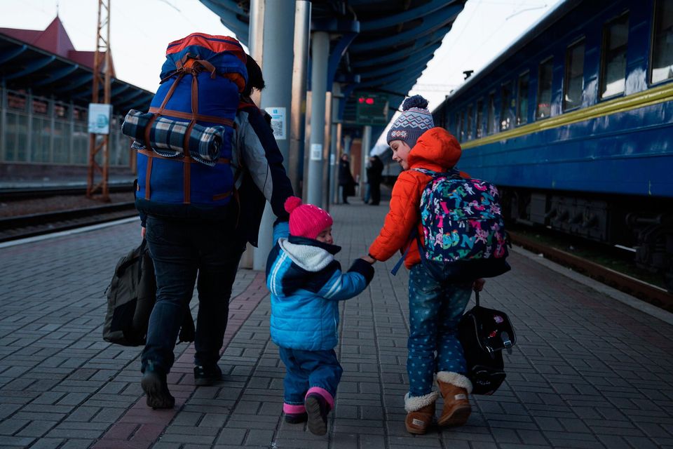 A woman walks with her children as she arrives by train from Odesa in Uzhhorod, Ukraine. Photo by Zuzana Gogova/Getty Images
