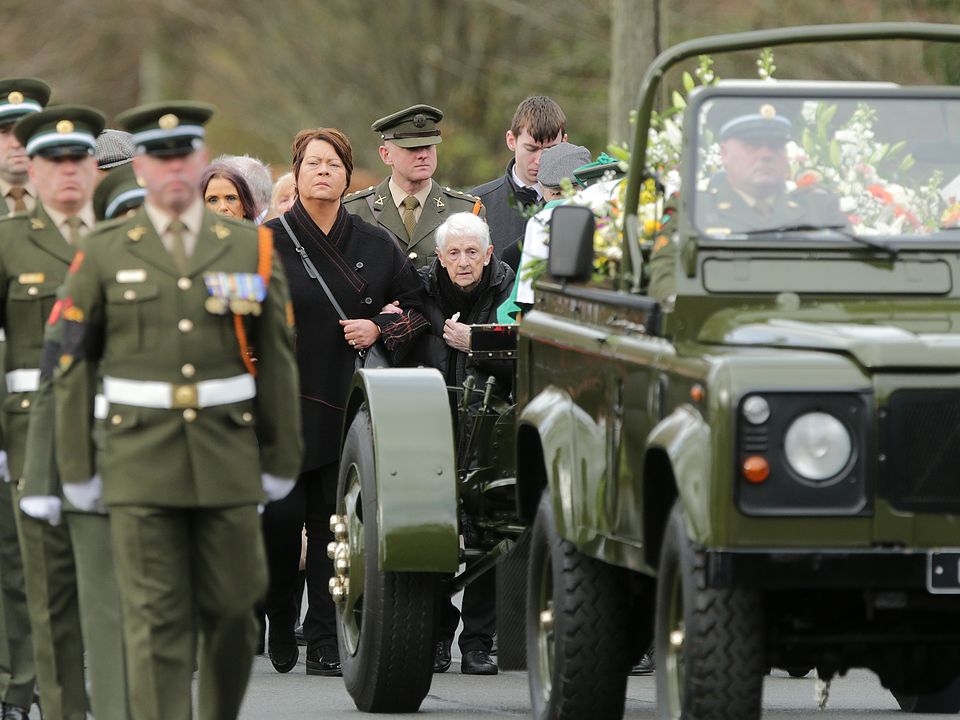 Mary O'Connell follows the remains of her son Acting Sergeant Major Declan O'Connell following his funeral mass in St Brigids Church in the Curragh Camp . Picture; Gerry Mooney